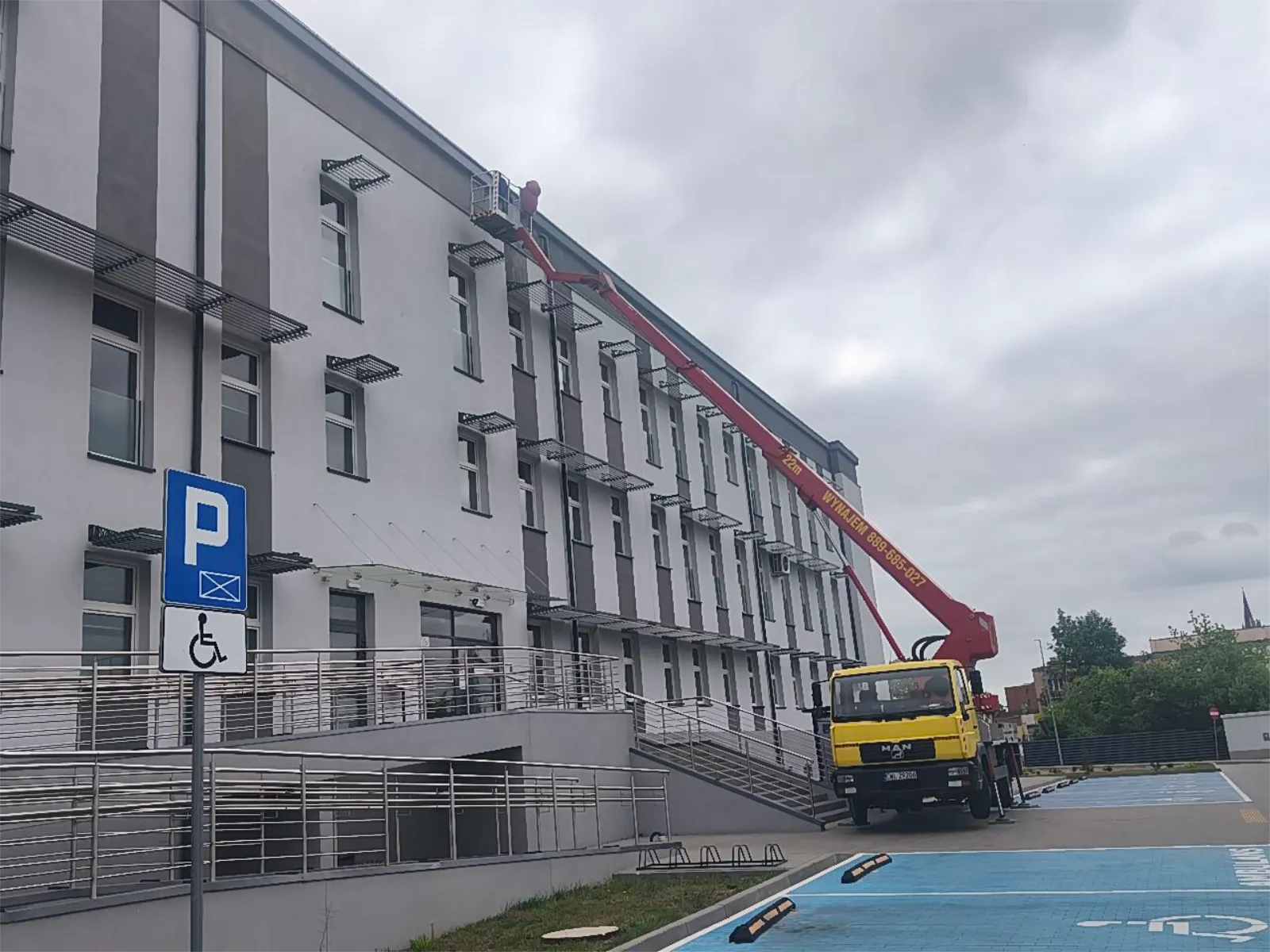 Prace na elewacji budynku z kosza podnośnika